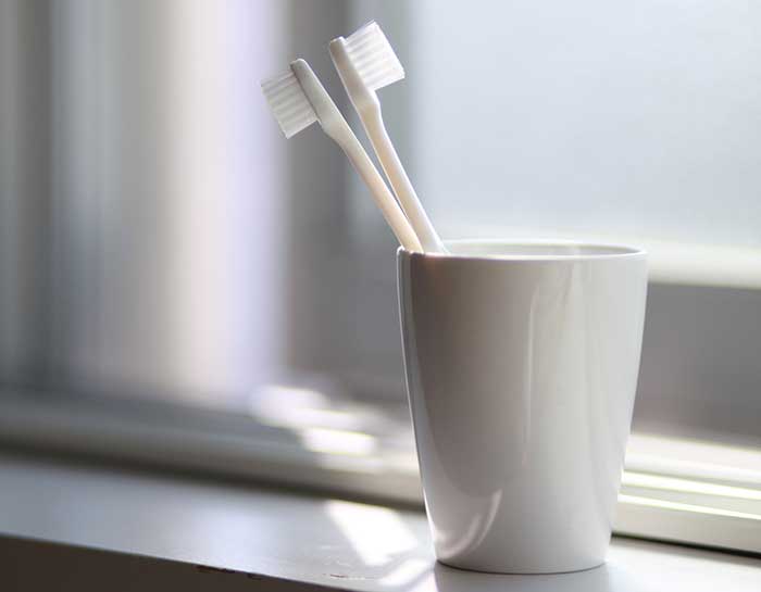 Tooth brushes in a glass