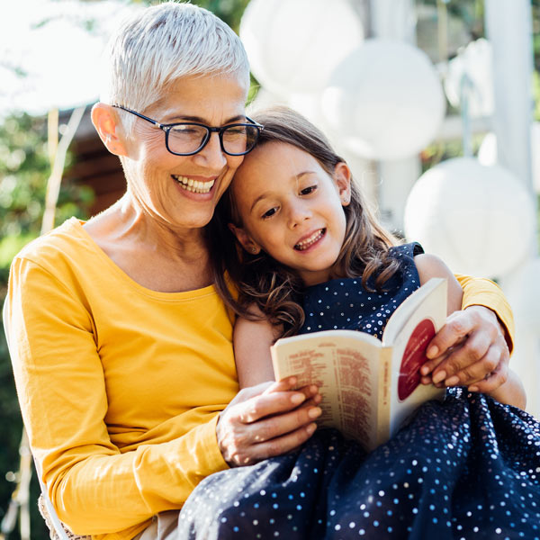 grandmother reading to granddaughter