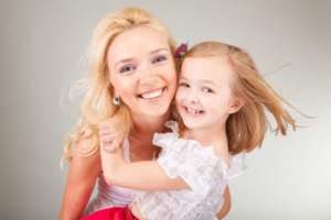 Mother and a small girl smiling