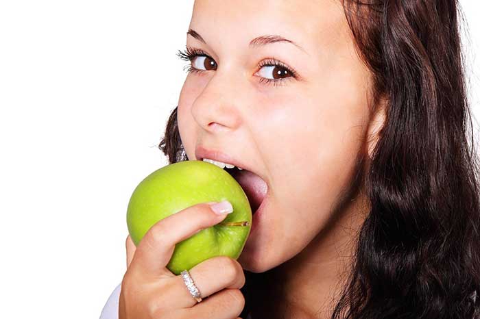 Girl biting a fruit