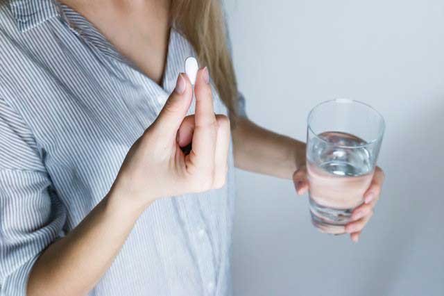 Lady taking a medicine