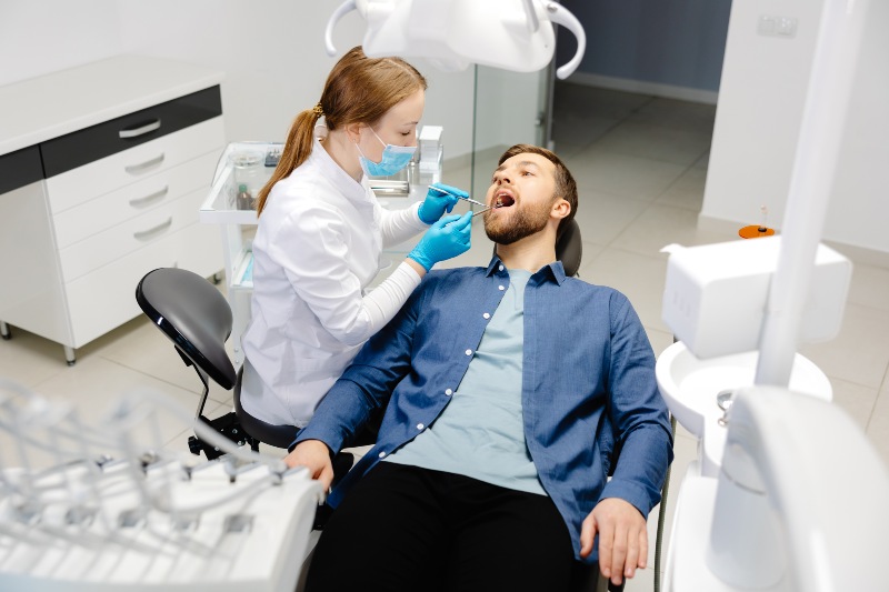 Dentist performing dental filling treatment in a modern clinic in Southfield, MI
