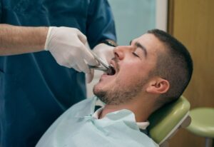 Careful tooth extraction procedure performed at dental office in Southfield, MI